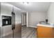 Kitchen area features stainless steel fridge, wood cabinets, and gray flooring at 971 Sims Nw Ave, Atlanta, GA 30318