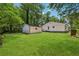 View of the home's backyard, detached garage, and trees at 1978 Ethel Ln, Decatur, GA 30032