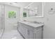 Modern bathroom with a double vanity, walk-in shower, and marble floors at 1978 Ethel Ln, Decatur, GA 30032