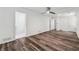 Light filled bedroom with wood floors, white walls, ceiling fan and multiple closets at 1978 Ethel Ln, Decatur, GA 30032