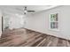 A well-lit room with wood floors, white walls, ceiling fan and dual pane windows at 1978 Ethel Ln, Decatur, GA 30032