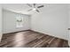This bedroom features wood flooring, a ceiling fan, and a window that lets in natural light at 1978 Ethel Ln, Decatur, GA 30032