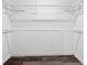 Empty walk in closet with built in shelving and wood floors at 1978 Ethel Ln, Decatur, GA 30032