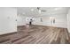 Open living room with wood floors, ceiling fan, and an open design leading to the kitchen at 1978 Ethel Ln, Decatur, GA 30032