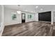 Bright living room featuring a modern light fixture, accent wall and luxury vinyl flooring at 1978 Ethel Ln, Decatur, GA 30032