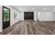 Bright living room featuring a modern light fixture, accent wall and luxury vinyl flooring at 1978 Ethel Ln, Decatur, GA 30032