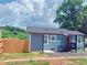 Charming home with gray siding, red door, black trim, and landscaped yard, perfect for Gathering living at 2526 Center Nw St, Atlanta, GA 30318