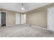 Spacious bedroom with neutral tones, a ceiling fan, and multiple doors at 3105 Sumac Dr, Atlanta, GA 30360