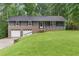Charming home featuring a brick and siding exterior, a well-manicured lawn, and an attached two-car garage at 3105 Sumac Dr, Atlanta, GA 30360