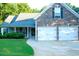 Charming home featuring a stone facade, two-car garage, well-maintained lawn, and covered front porch at 85 Lamar Ln, Covington, GA 30016