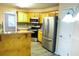 Bright kitchen features stainless steel appliances, light wood cabinets, and bar top perfect for entertaining at 85 Lamar Ln, Covington, GA 30016