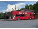 Unique double-decker bus restaurant/bar with agave themed decor, parked with outdoor seating and stairs for access at 4876 Velva Nw Way, Lilburn, GA 30047