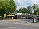 Exterior view of a restaurant with outdoor seating and yellow umbrellas, located on a corner lot at 4876 Velva Nw Way, Lilburn, GA 30047