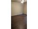 A room with brown floors and a ceiling fan overhead at 1009 Autumn Crest Ct, Stone Mountain, GA 30083