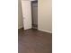 A bedroom with wood-look floors and a white paneled door leading to a closet at 1009 Autumn Crest Ct, Stone Mountain, GA 30083