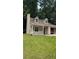 Charming home featuring a well-maintained lawn, classic architectural design, and an inviting entrance at 1009 Autumn Crest Ct, Stone Mountain, GA 30083