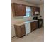 Functional kitchen with essential appliances, wood cabinetry, and ample counter space, awaiting a personal touch at 1009 Autumn Crest Ct, Stone Mountain, GA 30083