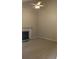 Bright living room showcasing neutral walls, tile floors, a ceiling fan, and a cozy fireplace at 1009 Autumn Crest Ct, Stone Mountain, GA 30083