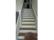 Staircase with white painted banister and natural wood steps provides a classic, functional access point at 1009 Autumn Crest Ct, Stone Mountain, GA 30083
