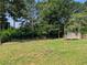 Large backyard with trees and a storage shed at 1041 Waverly Drive Dr, Lawrenceville, GA 30046