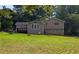 Back exterior view of the house with a deck overlooking the lawn at 1041 Waverly Drive Dr, Lawrenceville, GA 30046