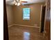Bedroom featuring light brown walls and wood-look flooring, plus a window at 1041 Waverly Drive Dr, Lawrenceville, GA 30046