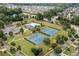 Aerial view of community amenities showcasing the pool, tennis courts, clubhouse, and well-maintained surroundings at 1170 Shellnut Trl, Hoschton, GA 30548