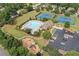 Aerial view of community amenities featuring pool, tennis courts, playground, clubhouse, and parking at 1170 Shellnut Trl, Hoschton, GA 30548