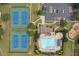 Overhead view of the neighborhood amenities including tennis courts, pool and clubhouse, playground, and parking lot at 1170 Shellnut Trl, Hoschton, GA 30548