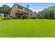 Expansive green backyard, a wooden deck, and lush trees are showcased in this inviting outdoor space at 1170 Shellnut Trl, Hoschton, GA 30548
