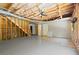 Spacious unfinished basement with a ceiling fan and door ready for customization at 1170 Shellnut Trl, Hoschton, GA 30548