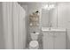 Clean bathroom featuring a shower with curtain and a vanity with a white countertop and storage at 1170 Shellnut Trl, Hoschton, GA 30548