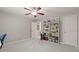 Bedroom showcasing a ceiling fan, neutral carpet, and a full bookcase at 1170 Shellnut Trl, Hoschton, GA 30548
