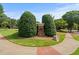 Community entrance featuring landscaped shrubs and signage, welcoming residents and visitors at 1170 Shellnut Trl, Hoschton, GA 30548