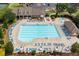 Aerial view of community pool and lounge area with many chairs for residents to relax and enjoy at 1170 Shellnut Trl, Hoschton, GA 30548
