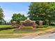 Well-manicured Trilogy Park community sign welcomes residents with colorful flowers and lush landscaping at 1170 Shellnut Trl, Hoschton, GA 30548