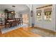 Formal dining room featuring hardwood floors, a classic chandelier, and views to the front yard at 1170 Shellnut Trl, Hoschton, GA 30548