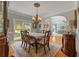 Dining room with hardwood floors and vintage chandelier next to the formal living room at 1170 Shellnut Trl, Hoschton, GA 30548