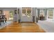 Inviting entryway with hardwood floors flowing into a carpeted formal living space with large windows at 1170 Shellnut Trl, Hoschton, GA 30548