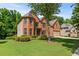 Charming brick home with a manicured lawn and mature trees offering great curb appeal at 1170 Shellnut Trl, Hoschton, GA 30548