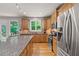 Stainless steel appliances and granite countertops are featured in this kitchen at 1170 Shellnut Trl, Hoschton, GA 30548