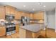 Open concept kitchen with stainless steel appliances, center island and granite countertops at 1170 Shellnut Trl, Hoschton, GA 30548