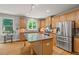 Bright kitchen with stainless steel appliances and granite countertops at 1170 Shellnut Trl, Hoschton, GA 30548