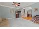 Cozy living room with neutral-toned walls, plush carpeting, and an adjacent dining area at 1170 Shellnut Trl, Hoschton, GA 30548