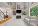 Open floor plan with living room, fireplace, custom built-ins, and large windows at 1170 Shellnut Trl, Hoschton, GA 30548