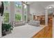 Open concept living room featuring soaring ceilings and oversized windows offering scenic outdoor views at 1170 Shellnut Trl, Hoschton, GA 30548