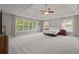 Large main bedroom features tray ceiling, neutral carpet, large windows, and sitting area at 1170 Shellnut Trl, Hoschton, GA 30548