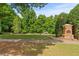 Charming Autumn Park entrance with lush landscaping and stone signage, offering a peaceful retreat at 1170 Shellnut Trl, Hoschton, GA 30548