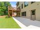 Concrete patio with stairs leading to an upper deck, and a view of the expansive backyard and the house at 1170 Shellnut Trl, Hoschton, GA 30548