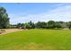 Community park features a playground, swings, benches, and expansive grassy field on a sunny day at 1170 Shellnut Trl, Hoschton, GA 30548